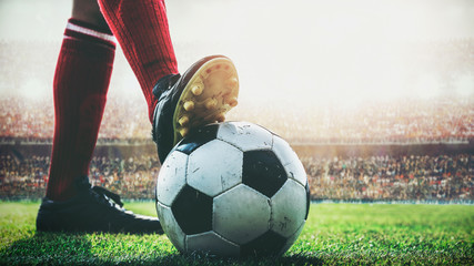 feet of soccer player tread on soccer ball for kick-off in the stadium - obrazy, fototapety, plakaty