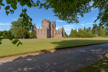 Fototapeta premium View of Glamis Castle in Scotland. Glamis Castle is situated close to the village of Glamis in Angus. It is the home of the Earl and Countess of Strathmore and Kinghorne, and is open to the public.
