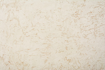 gray texture of the surface of the wall covered with decorative plaster of the woodworm type, close-up architecture abstract background