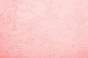 pink texture of the surface of the wall covered with decorative plaster of the woodworm type,...