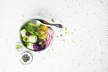 Vegetarian dinner buddha bowl. Vegetables, rice, micro greens, avocado bowl with chickpeas. Top...