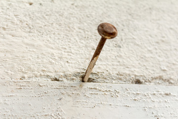 Nail or tack use for cement wall.