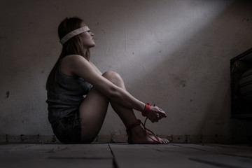 Victims of abducted women get wrists and feet in red. You have no way to fight or resist. She needs help. Hostage concept or female kidnapped from robber. Copy space. Dark Concepcion.
