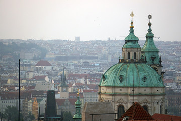 Fototapeta na wymiar Panorama of Prague at dawn in front of the church of Saint Nicholas, Prague, Czech Republic
