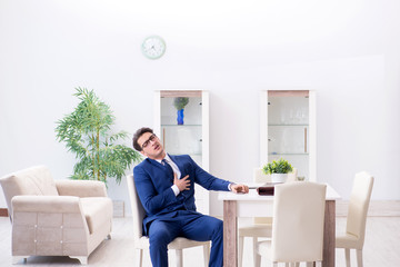 Bankrupt businessman having heart attack at home