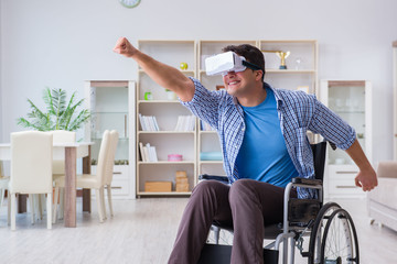 Disabled man studying with virtual reality glasses