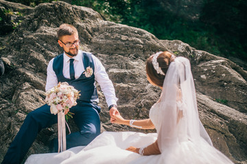 Couple newlyweds bride and groom kiss laughs and smiles to each other, happy and joyful moment. Man...