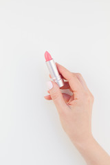 Woman hand with pink lipstick