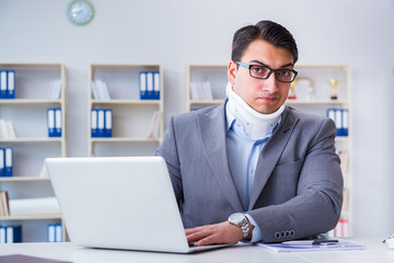 Businessman with neck injury working in the office