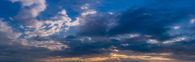 Naklejka na ściany i meble Beautiful sunset sky with clouds and orange strip along the horizon.