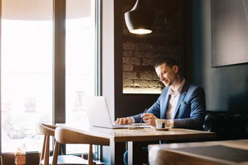 Successful young businessman is working with a program on his notebook. Designer developing the prototype of a web site. Popular video blogger streams online. Programmer developing investment area. 