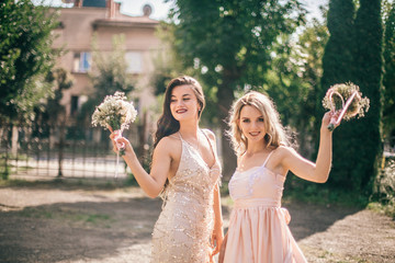 Beautiful bridesmaids at the wedding. Lovely dresses. Grils with flowers. Funny weddings moments.