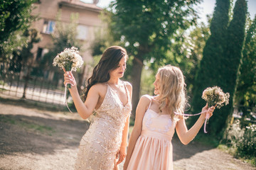 Obraz premium Beautiful bridesmaids at the wedding. Lovely dresses. Grils with flowers. Funny weddings moments.