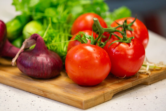 Image of a variety of colorful vegetables on a cutting wooden board