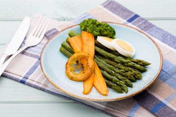 Fried asparagus with broccoli and lemon and carrot.