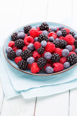 Fresh raspberries in a plate on a  vintage background.