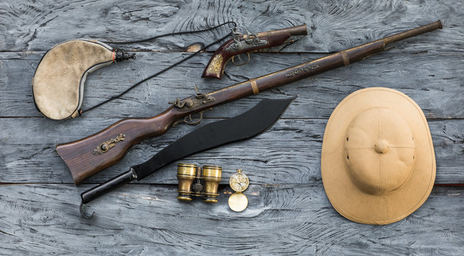 Fototapeta vintage hunter accessories, cork hunter's helmet and old gun, safari
