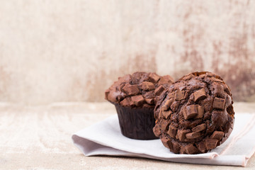 Homemade muffins with chocolate, vintage background.