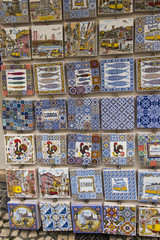 Traditionally decorated ceramic tiles for sale as souvenirs in front of a street shop in Lisbon