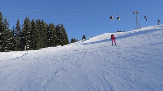 Skier Skiing Down Carving On The Slope In The Mountains Background The Funicular