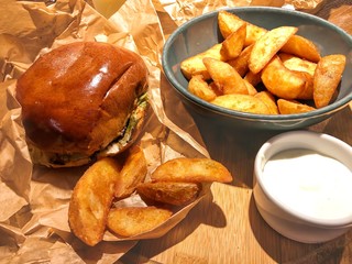 Tasty beef burger with fried potato segments