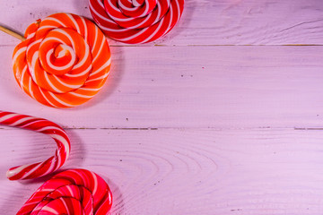 Different lollipops on a wooden table. Top view