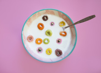 Bowl of milk and cereal with pugs floating in it. 