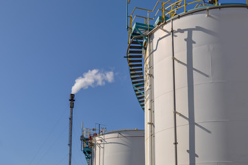 Vue d'une torche industrielle et d'un bac de stockage sur une plateforme industrielle
