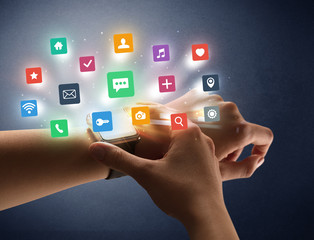 Naked female hand with smartwatch and  application labels around and dark background