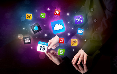 Male hands touching interactive table with colorful application icons on it 