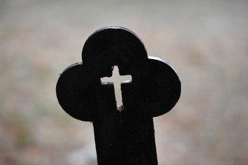 A 120 years old tombstone in form of a christian cross on a tomb in Berlin-Germany