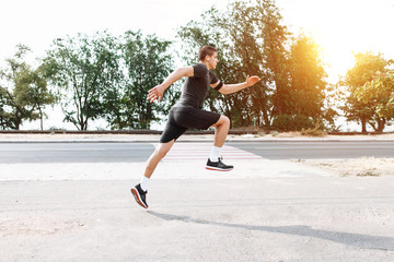 A young man makes a morning jog in the streets, sports training