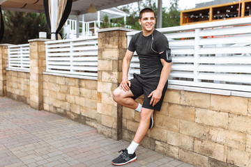 Athlete man posing against the wall, morning jog, training