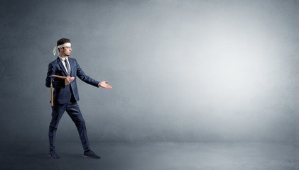 Fototapeta premium Small karate man fighting in an empty grey copy space