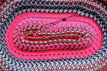 Vibrant fuchsia pink with white and blue rolled up Peruvian fabric for background, banner, texture 