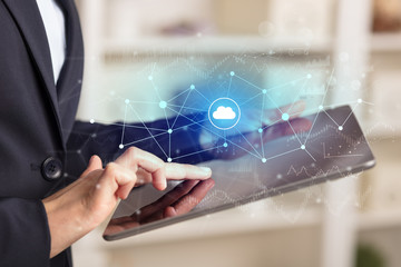 Business woman using tablet with financial, cloud connectivity concept