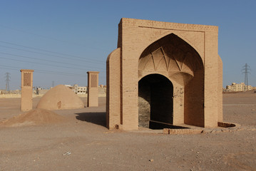 Persian well with twin cooling towers in the background