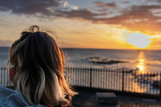 GIRL WATCHING WINTER SUNRISE