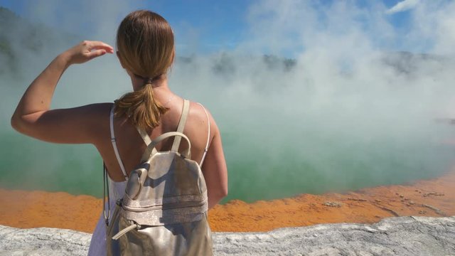 Woman tourist at geothermal basin, geyser - New Zealand, Rotorua, Waiotapu