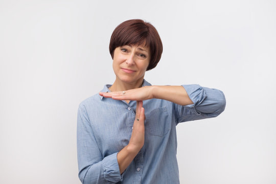 Middle Aged Woman In Blue Shirt Tired And Bored, Making A Timeout Gesture, Needs To Stop Because Of Work Stress, Time Concept