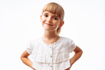 Portrait of a beautiful little girl, on a white background in the Studio, posing