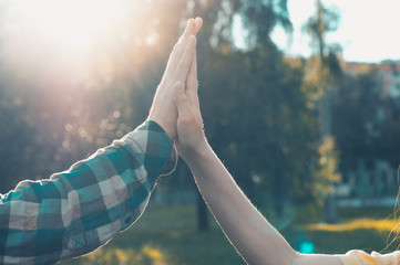 People celebrating success. Giving high five outdoors