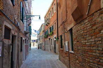 Fototapeta na wymiar An empty alley way (lane) between buildings in Venice