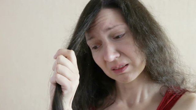 Woman is experiencing and cries.  Close-up, real time, indoors, three-quarters