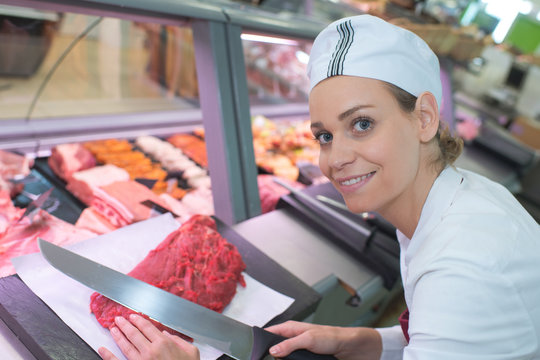 female butcher in a supermarket at work