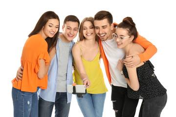 Fototapeta premium Young happy friends taking selfie against white background