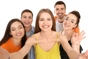 Young happy friends taking selfie against white background