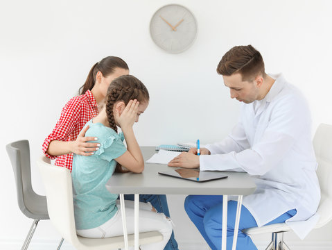 Young woman with her daughter having appointment at child psychologist office