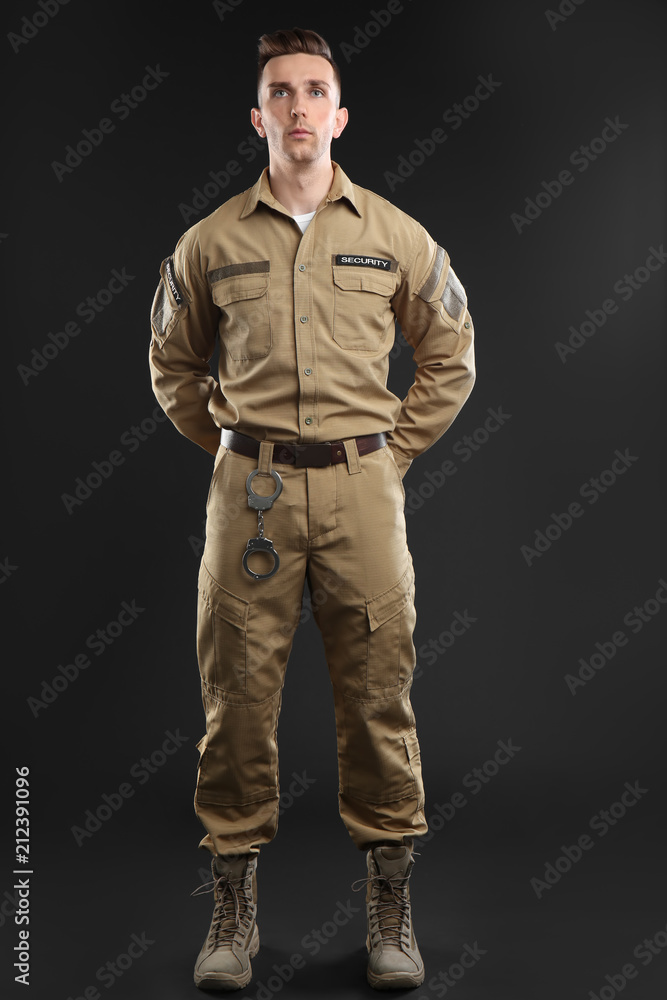 Wall mural male security guard in uniform on dark background