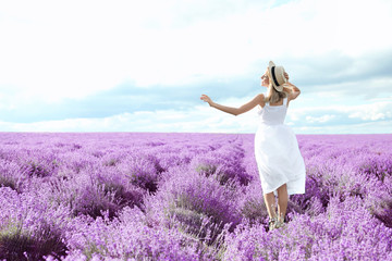 Young woman in lavender field on summer day